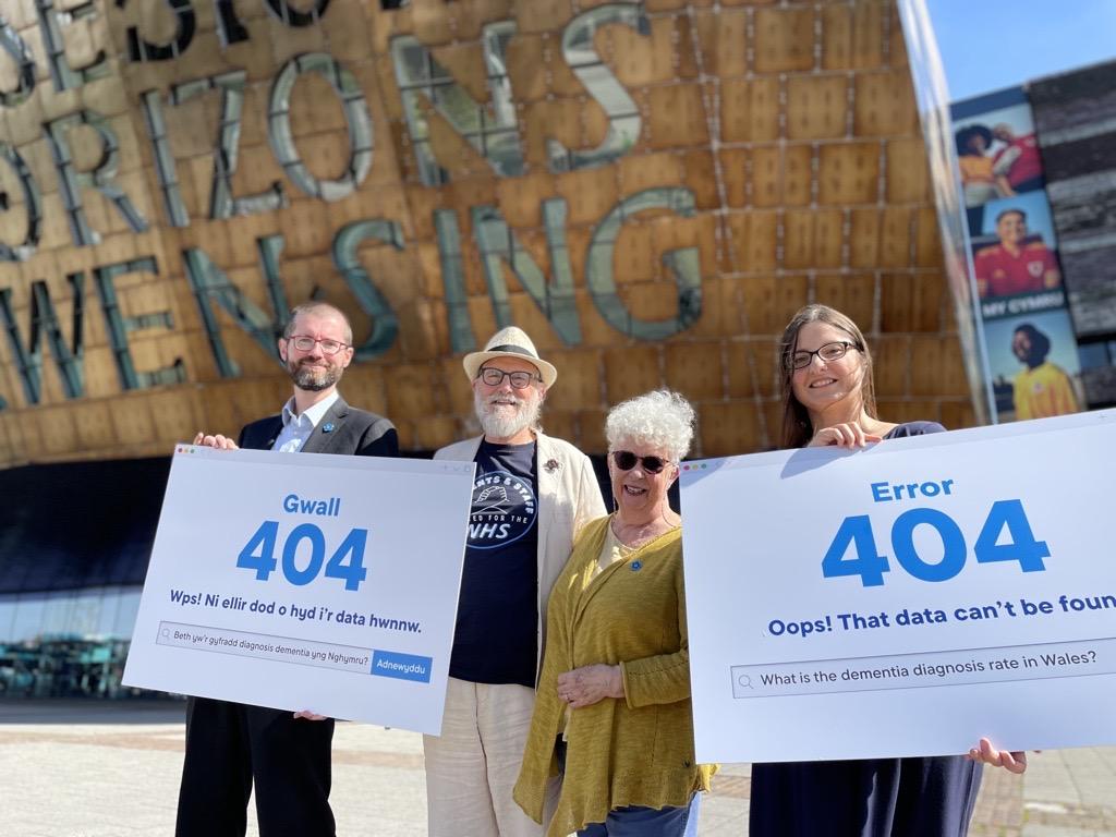 4 people stood with signs saying 'error: 404'