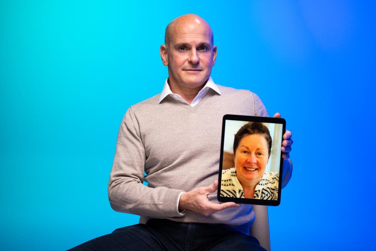Mark our dementia storyteller holding up a framed photo of his wife