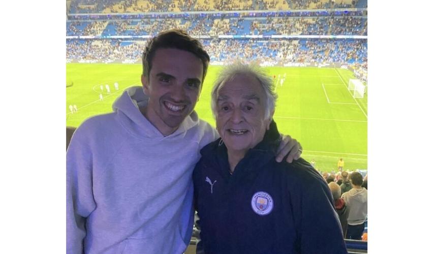 Charlie with his arm round his grandad at the football