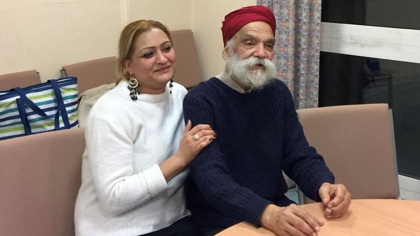 Suki sat at a table with her dad Mehal