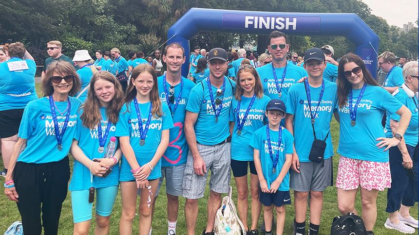 Michelle stands at the Memory Walk finish line with nine family member