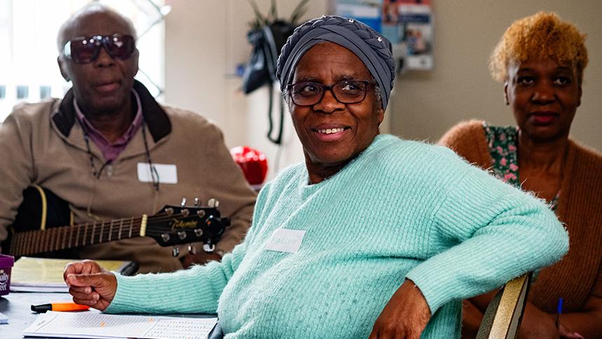 Three people sat at a table in Sheffield Memory Hub
