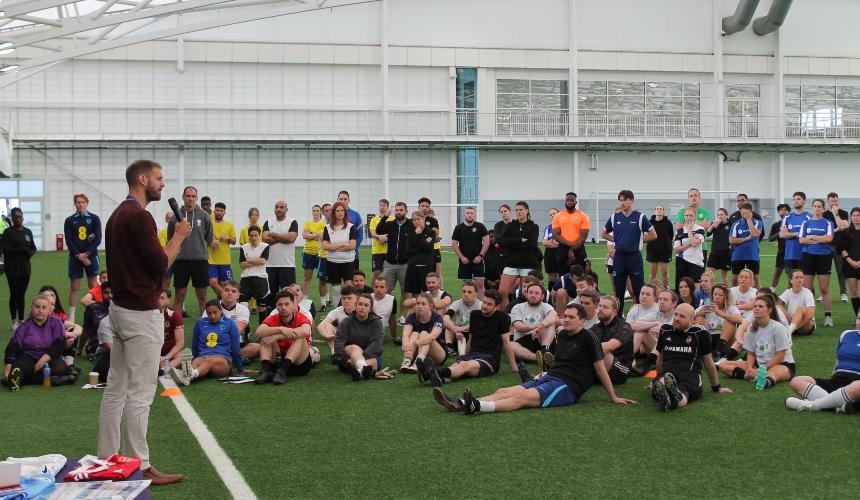 A man standing and talking to a group of people