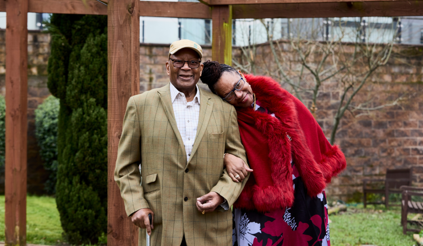 George and Tencie stand together outside
