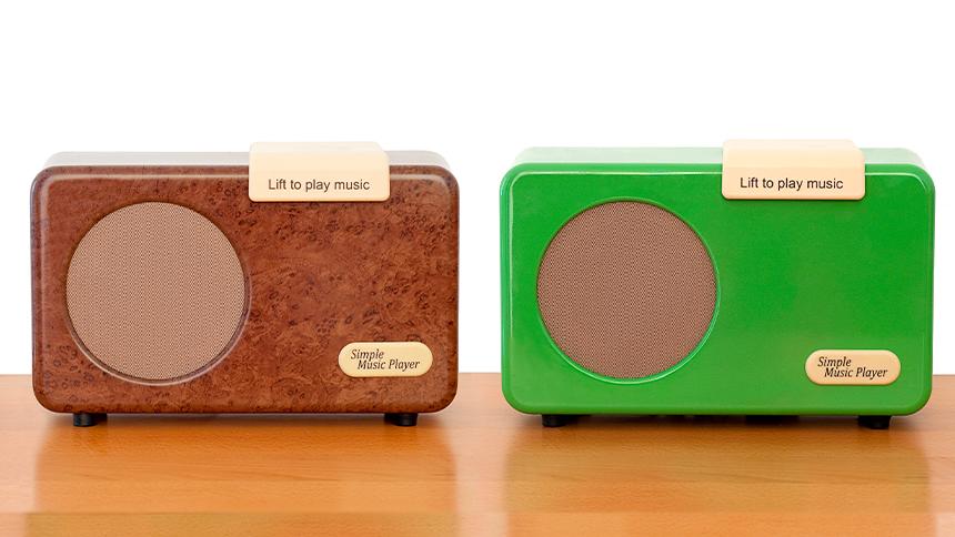 Simple music players in walnut burr and green sat on table