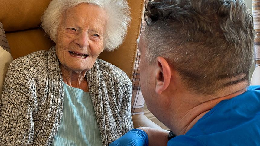 Person in care home talking to dentist