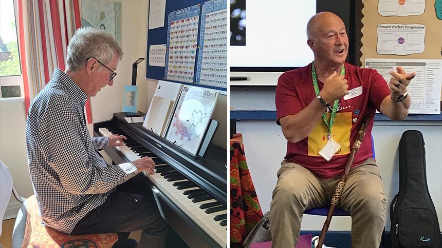 Steven is playing the piano, John is sat down and moving his arms as he speaks to a group of children