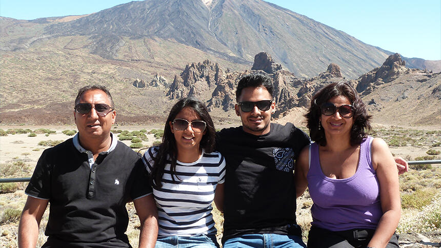 Parminder, daughter, son and Amar in front of a mountain