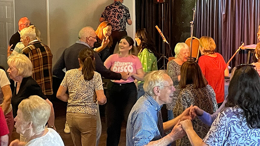 A group of people dancing in a hall