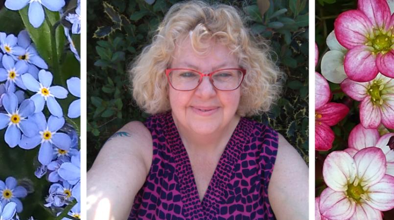 Tracey smiling with pictures of flowers in her garden