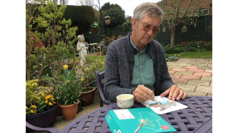 Keith Oliver painting in the garden