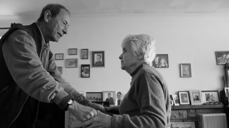 Kyra's grandad, Aubrey, helping Winnifred into her walking chair