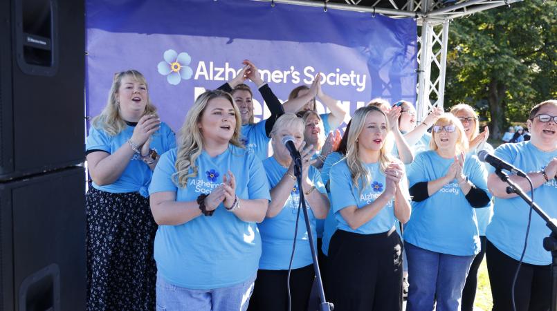 DVSA Choir performing on stage at the Cardiff Memory Walk
