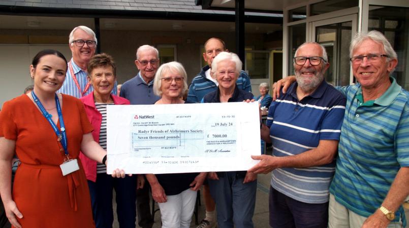 A group of volunteers accepting a cheque