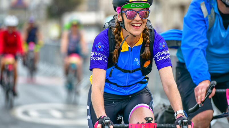 Lady cycling and smiling
