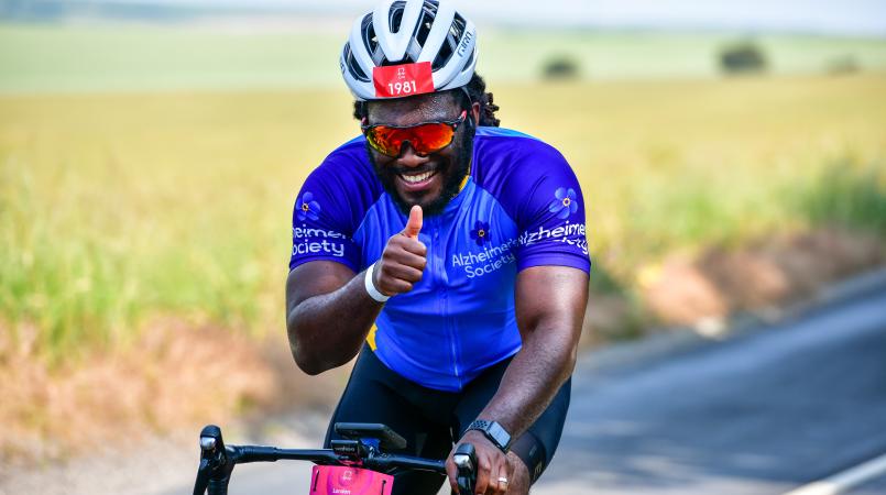 Man cycling thumbs up