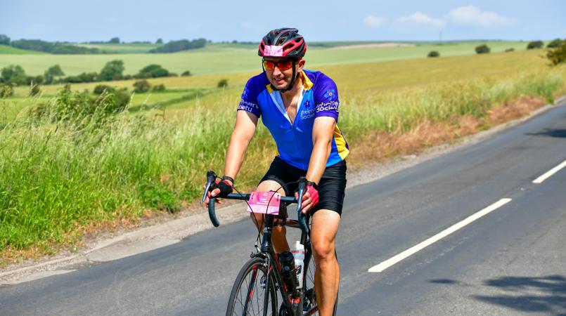 Man cycling in jersey and shorts