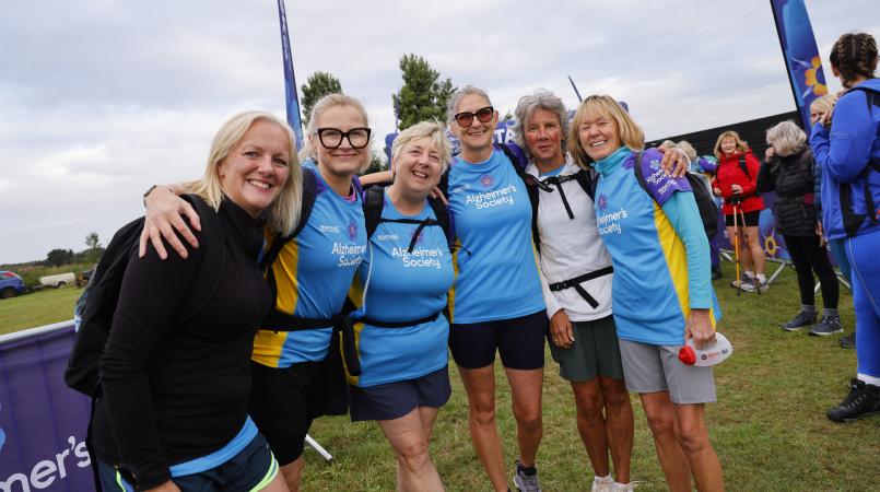 Group of women hugging at a start line.
