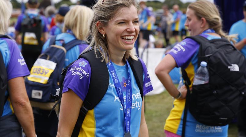 Woman smiling with a Trek26 medal around her neck.