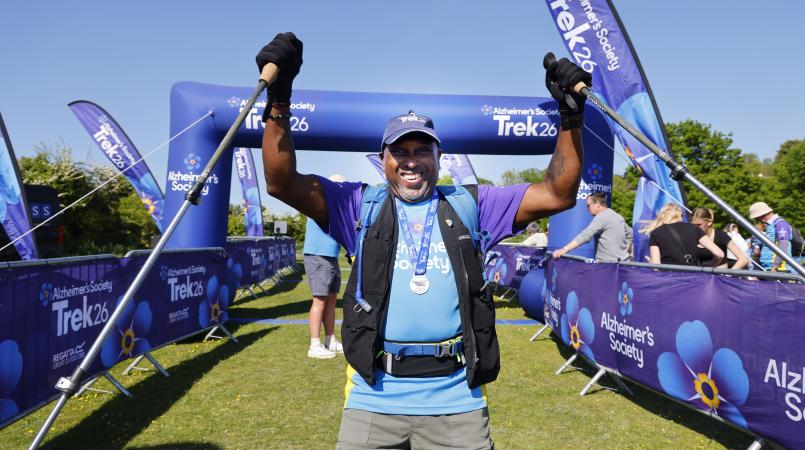 Man celebrating with the Trek26 finish line in the background.