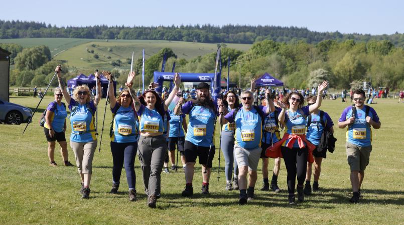 Group of trekkers smiling as they walk away from the event site.